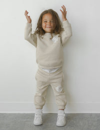 Our World Needs Jesus Beige Kids Crewneck Christian Sweatshirt